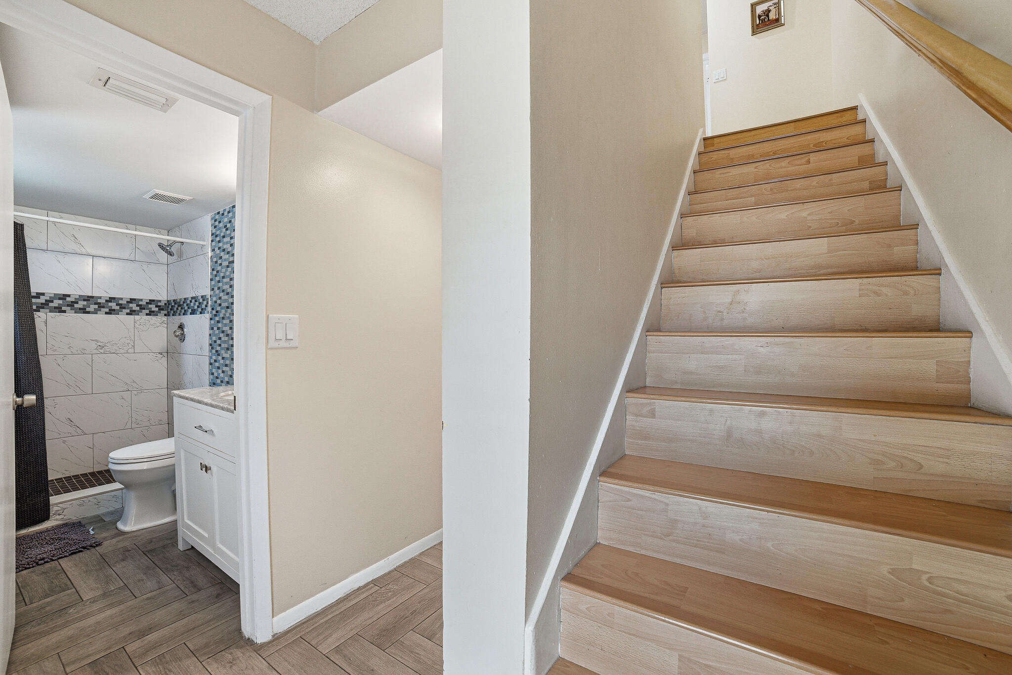 105 Deer Creek Road Deerfield Beach, FL 33442 - Photo 5 of 18 a view of a bathroom from the hallway