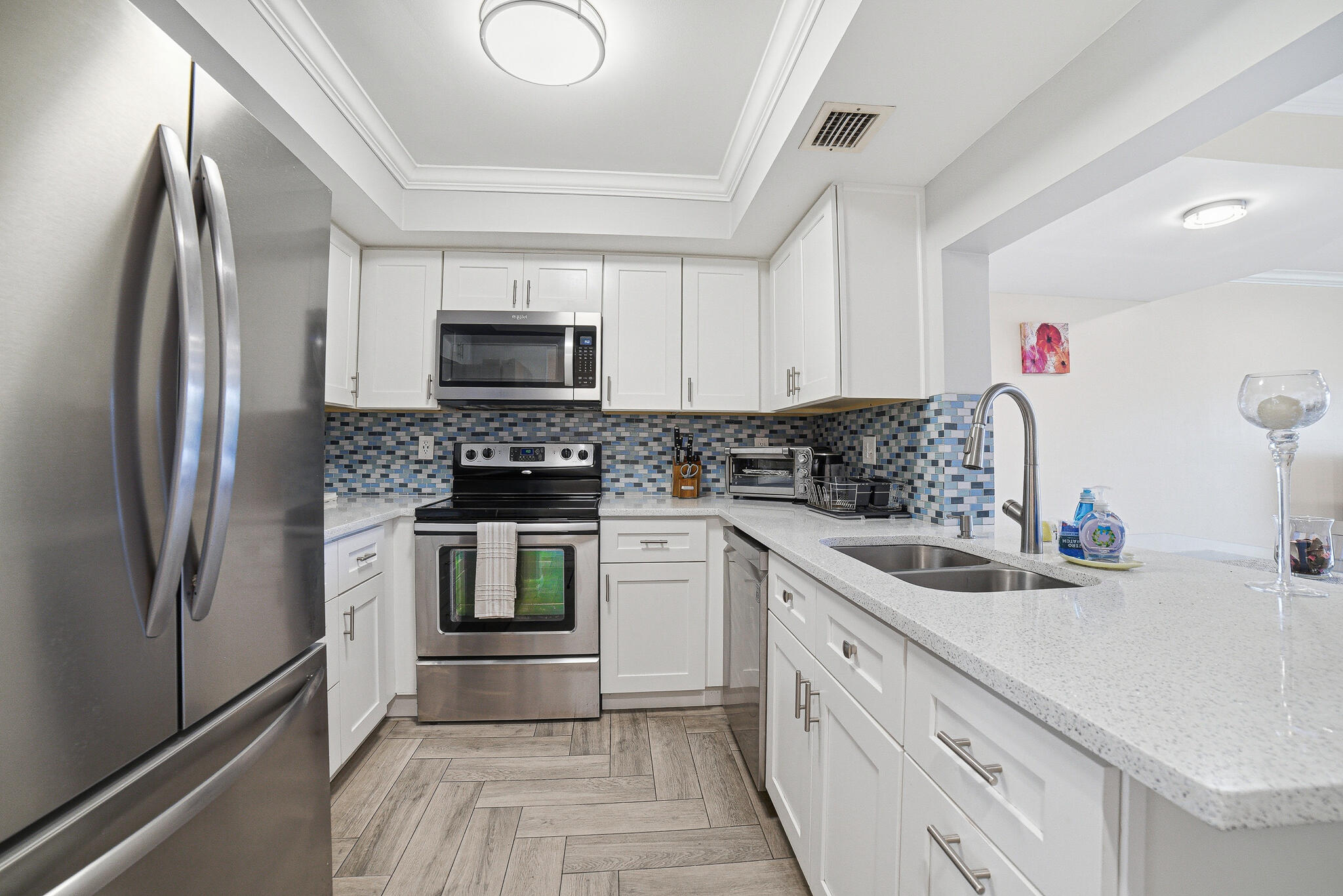 105 Deer Creek Road Deerfield Beach, FL 33442 - Photo 8 of 18 a kitchen with a sink stove and refrigerator