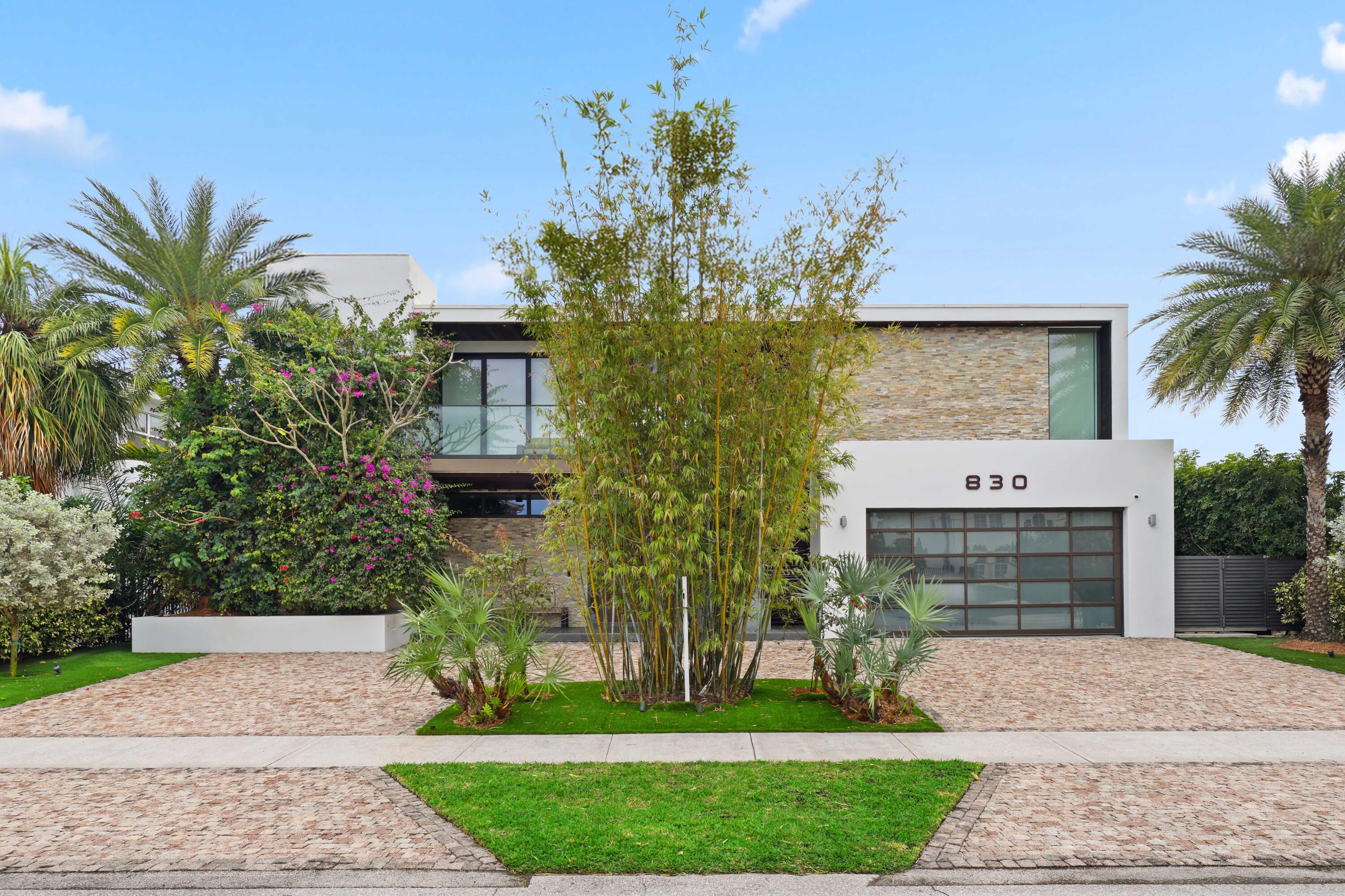 830 Northeast 71st Street Boca Raton, FL 33487 - Photo 67 of 77 a front view of a house with a garden