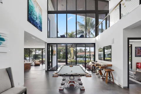 a kitchen with stainless steel appliances kitchen island granite countertop a table chairs and a refrigerator