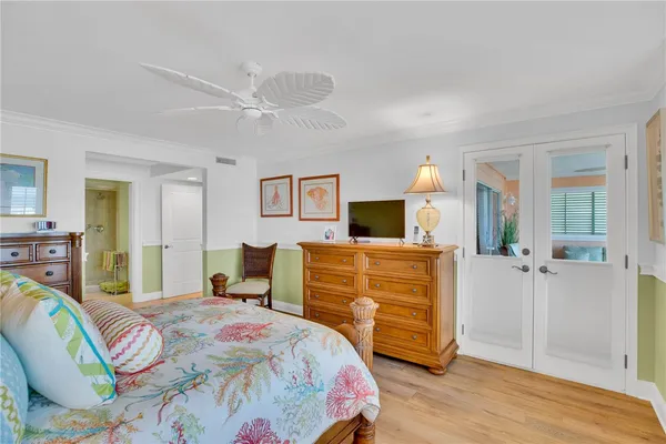 a bedroom with a bed and wooden floor