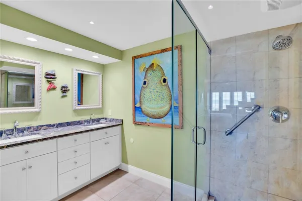 a bathroom with a granite countertop mirror and a sink