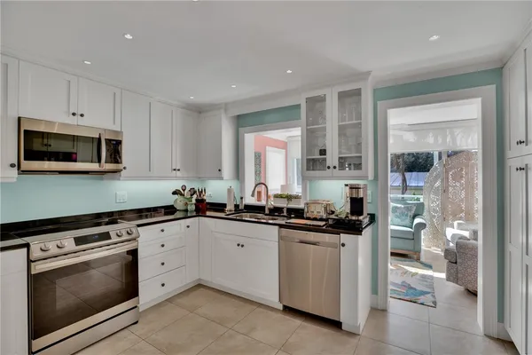 a kitchen with a sink stove and cabinets
