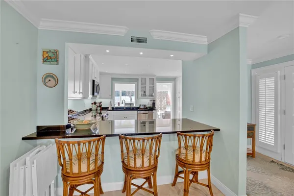 a view of a dining room with furniture and window
