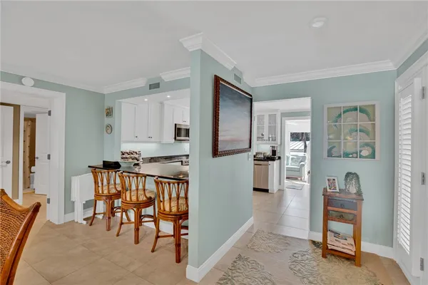 a kitchen with stainless steel appliances kitchen island granite countertop furniture and a refrigerator