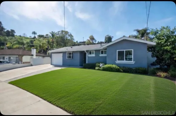 a front view of a house with a garden