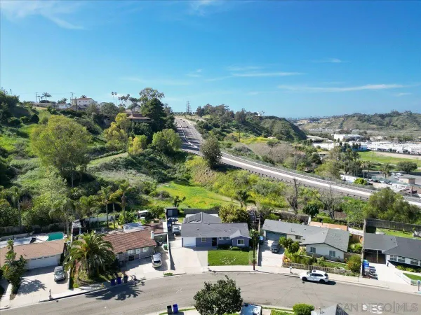 an aerial view of a house with a yard and large trees