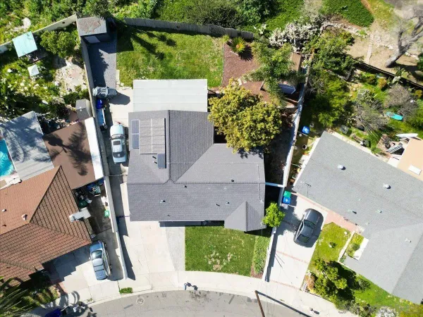 an aerial view of residential houses with outdoor space and street view