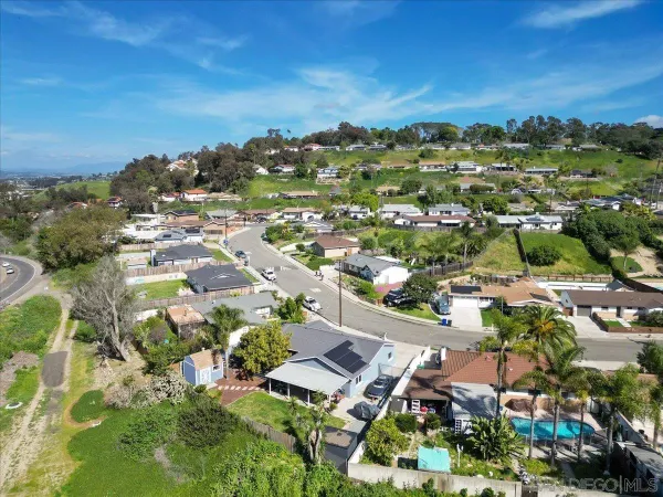 an aerial view of a houses with a yard