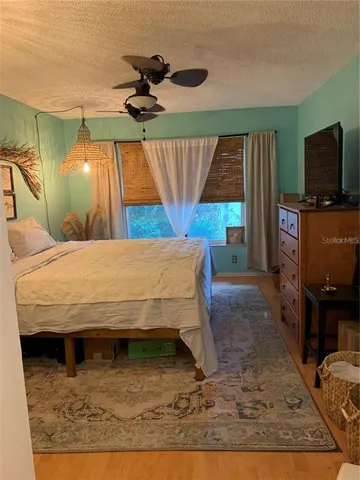 a bed sitting in a bedroom next to a window