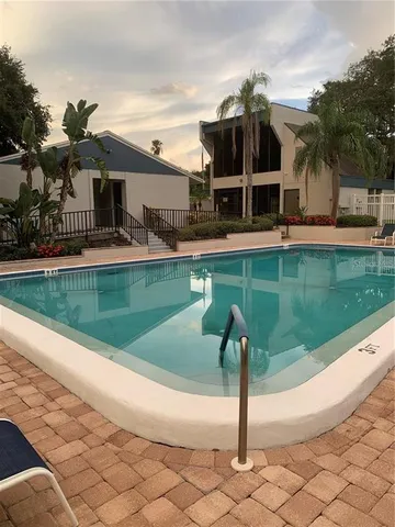 a swimming pool with outdoor seating yard and mountain view in back