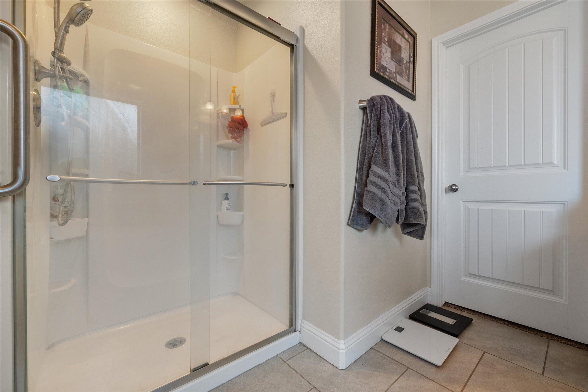 7038 95th Street Lubbock, TX 79424 - Photo 14 of 23 a bathroom with a shower