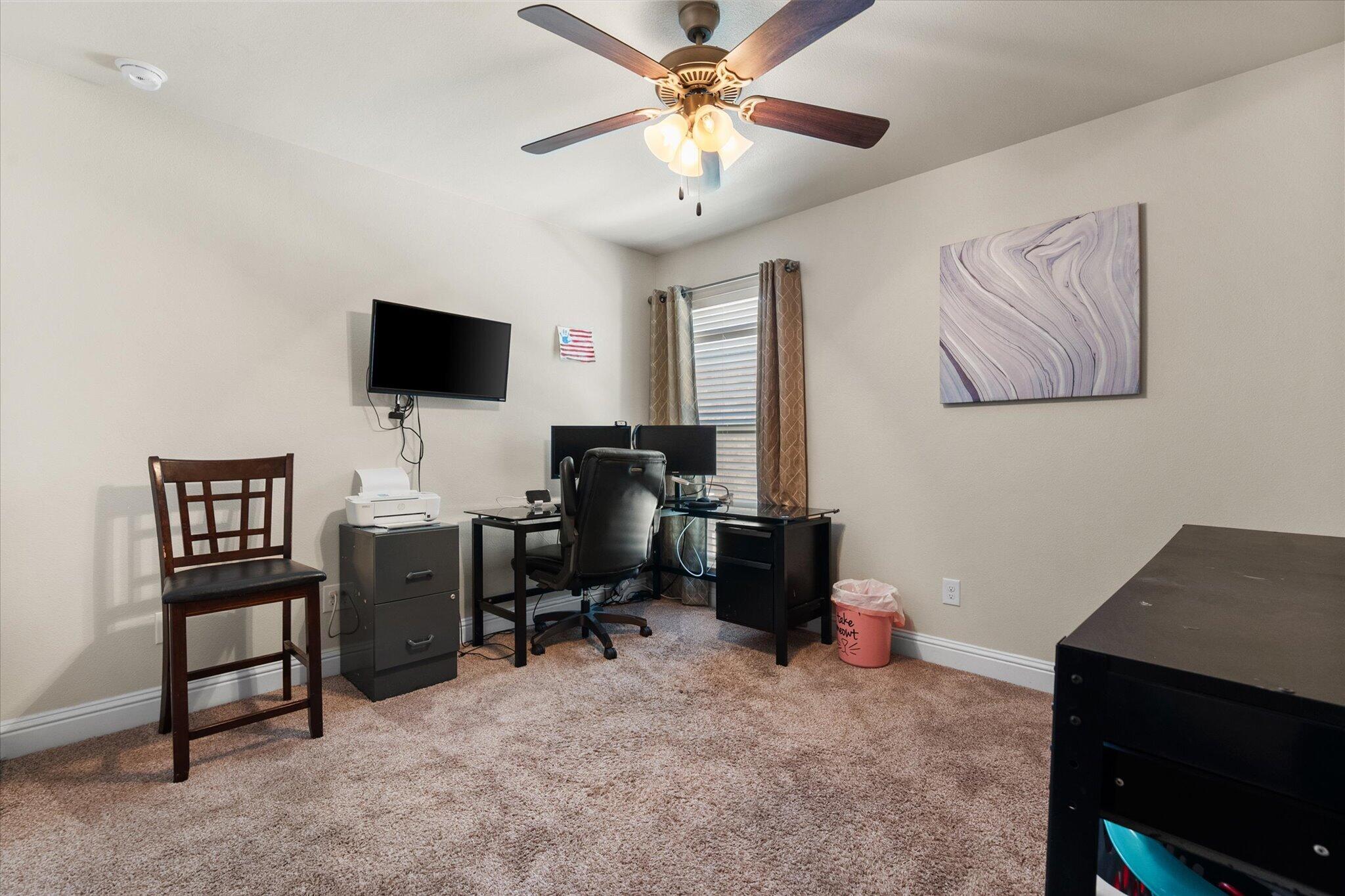 7038 95th Street Lubbock, TX 79424 - Photo 15 of 23 a view of a livingroom with workspace and a window