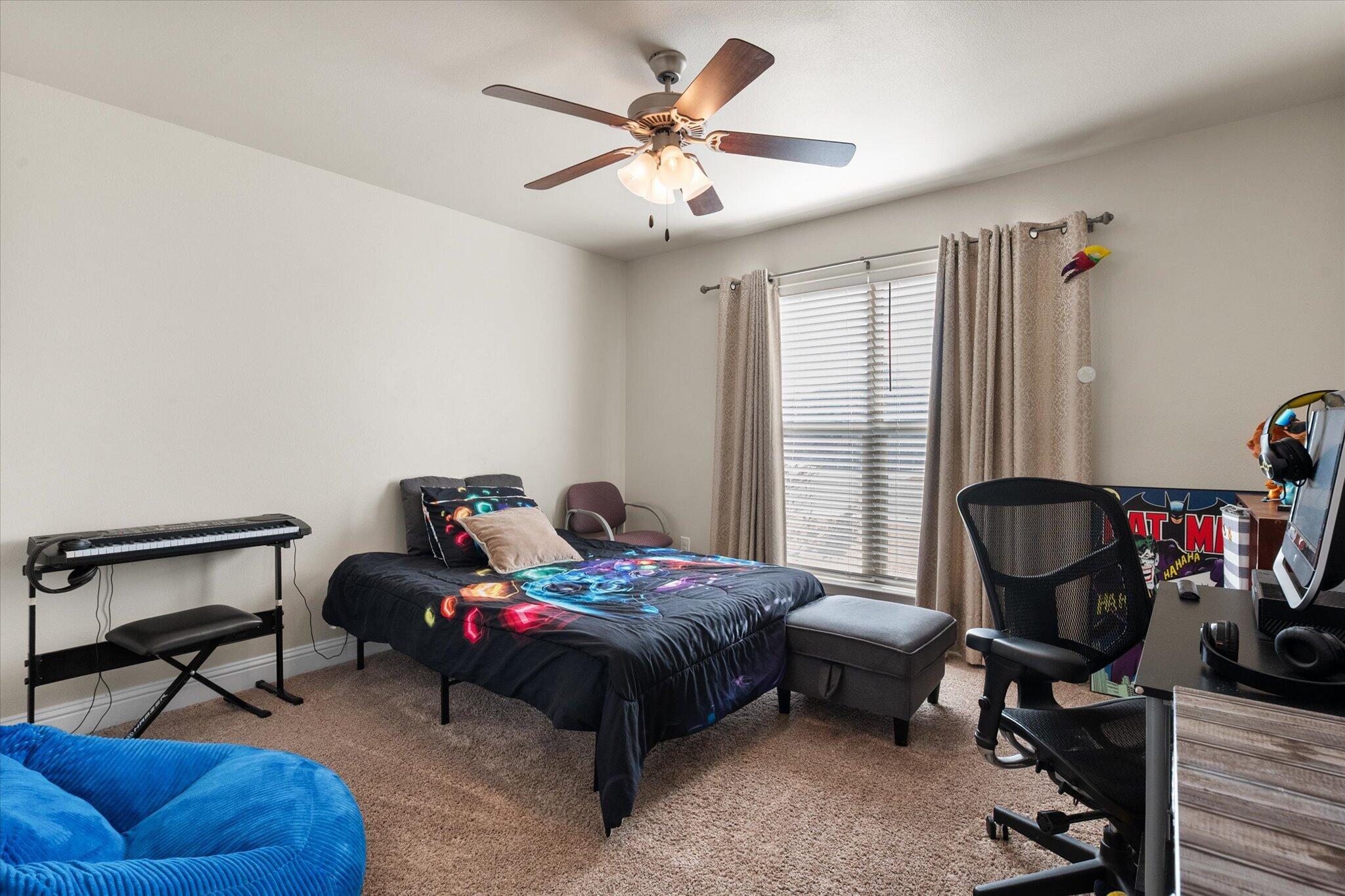 7038 95th Street Lubbock, TX 79424 - Photo 16 of 23 a bedroom with furniture and a bed