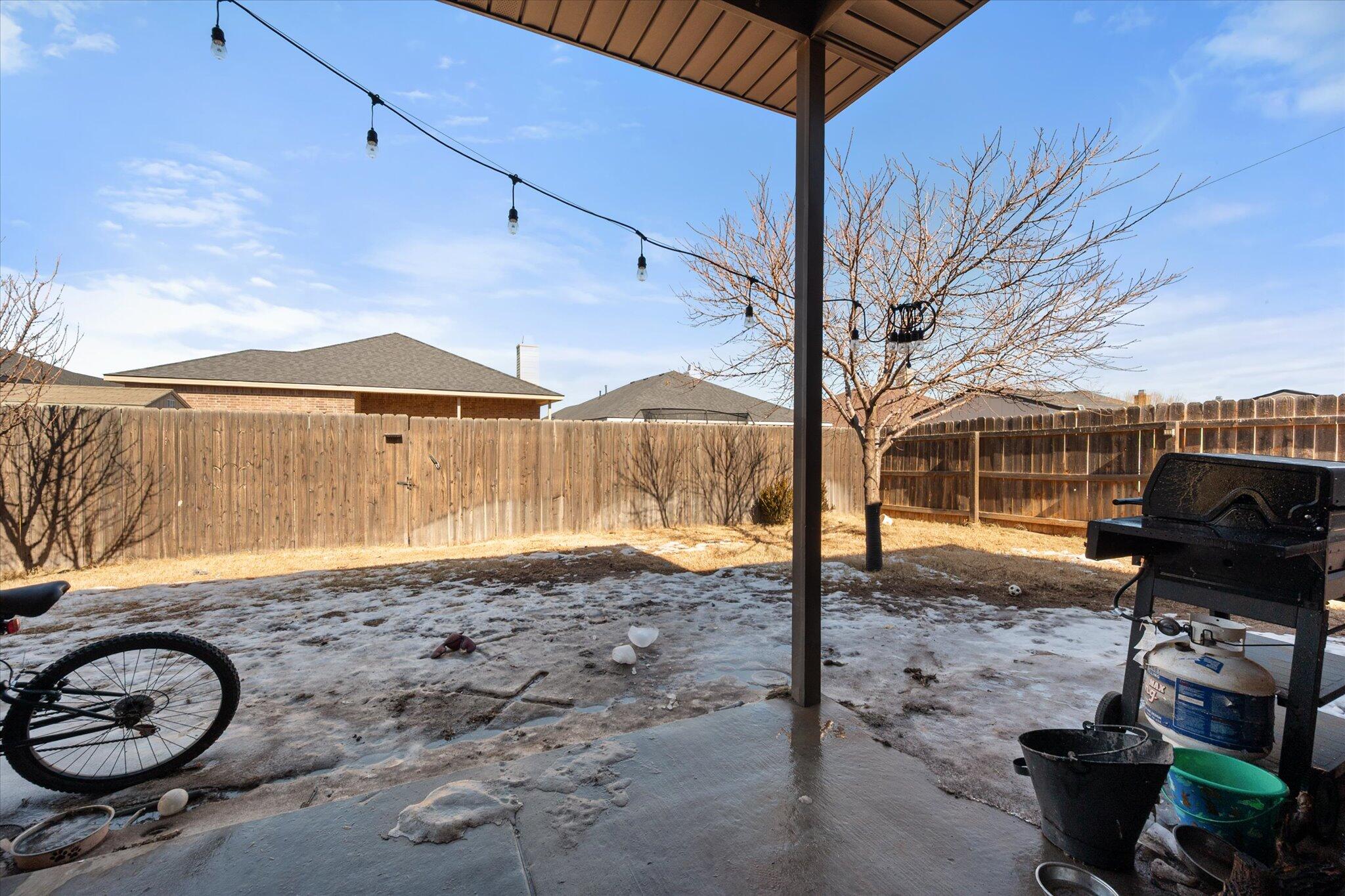 7038 95th Street Lubbock, TX 79424 - Photo 19 of 23 a front view of a house with garden