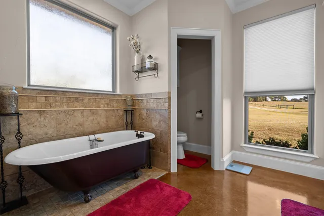 a bathroom with a tub sink and toilet