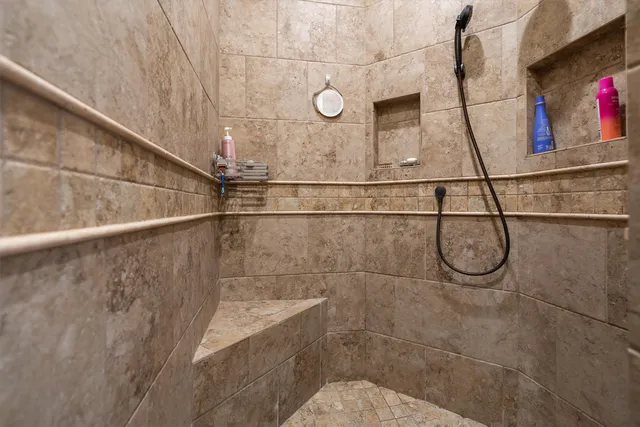 a bathroom with a shower and mirror
