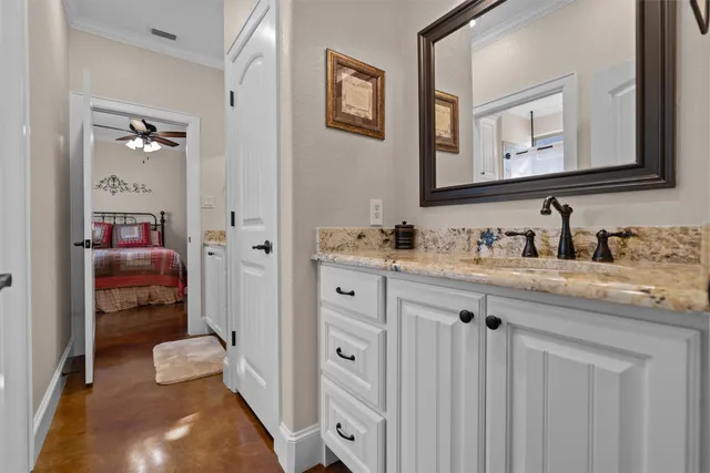 a bathroom with a sink vanity and a mirror