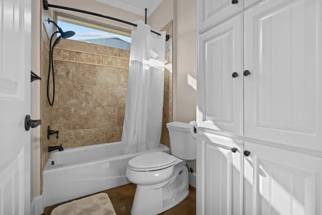 a bathroom with a toilet and a shower