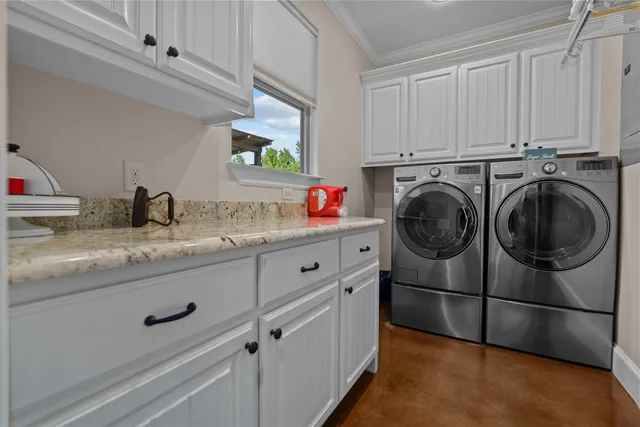 a utility room with sink dryer and washer