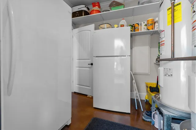 a white refrigerator freezer sitting inside of a kitchen