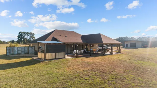 a view of a house with swimming pool and sitting area