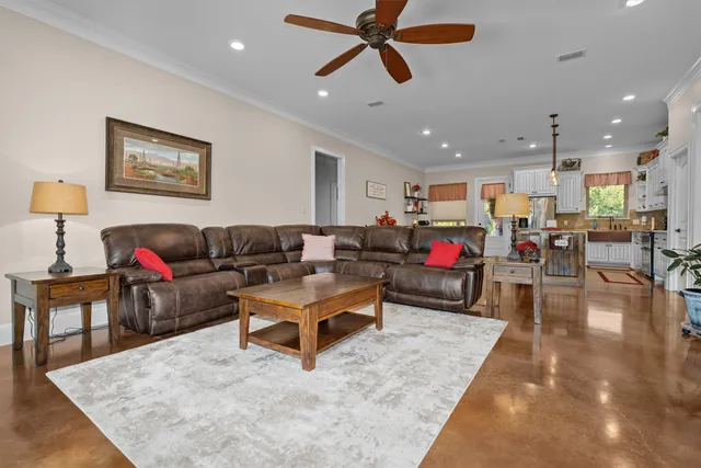a living room with furniture and kitchen view