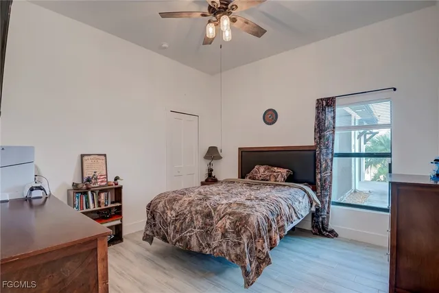 a view of a bedroom with furniture and floor to ceiling window