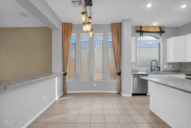 a bathroom with a granite countertop sink a mirror and a bathtub