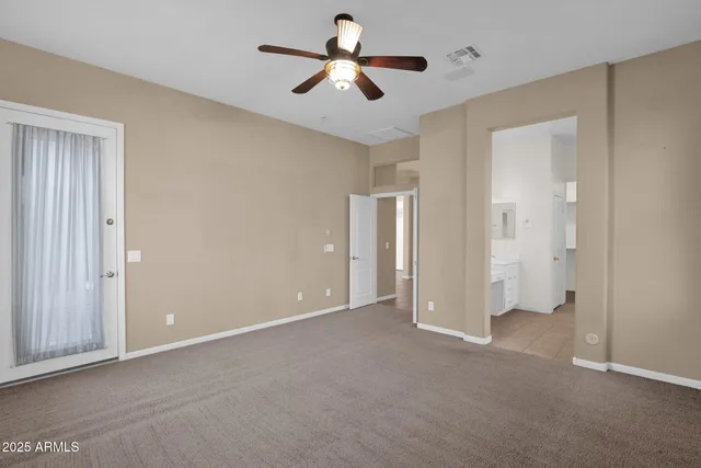 a view of empty room with ceiling fan