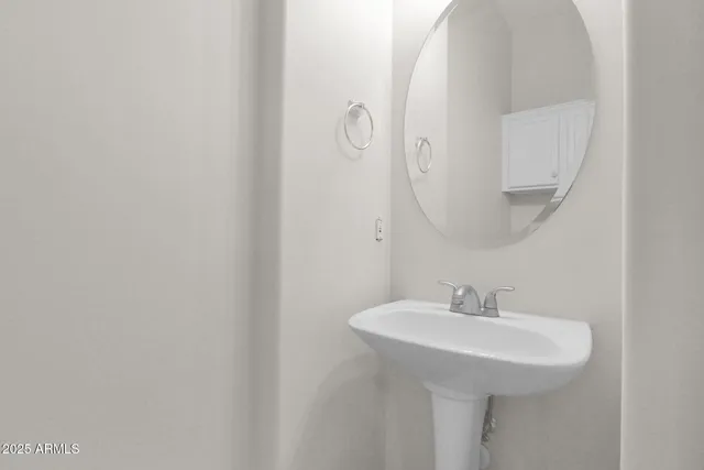 a bathroom with a sink and mirror