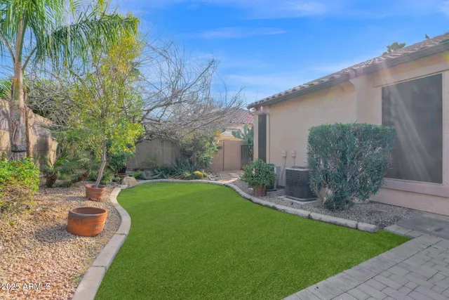 a view of a backyard with table and chairs and potted plants