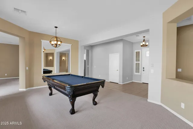 a living room with furniture a table and a chandelier