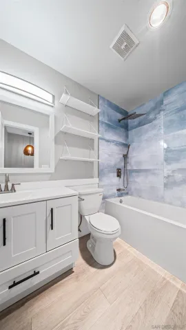 a bathroom with a sink a toilet and bathtub