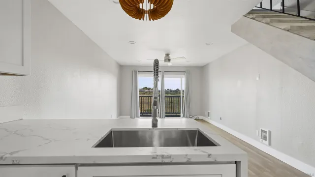 a kitchen with a sink and large window