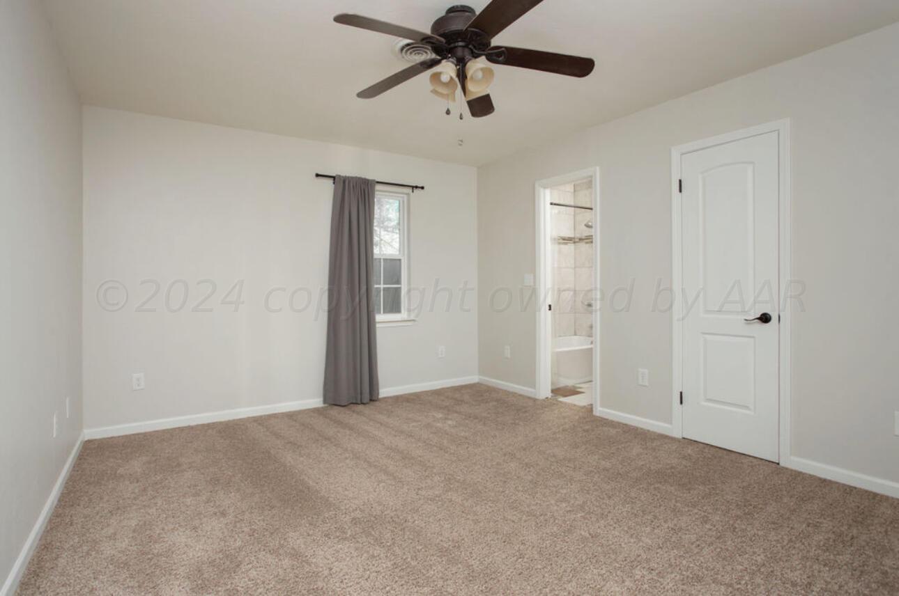 4818 Arden Road Amarillo, TX 79110 - Photo 18 of 29 a view of an empty room and chandelier fan