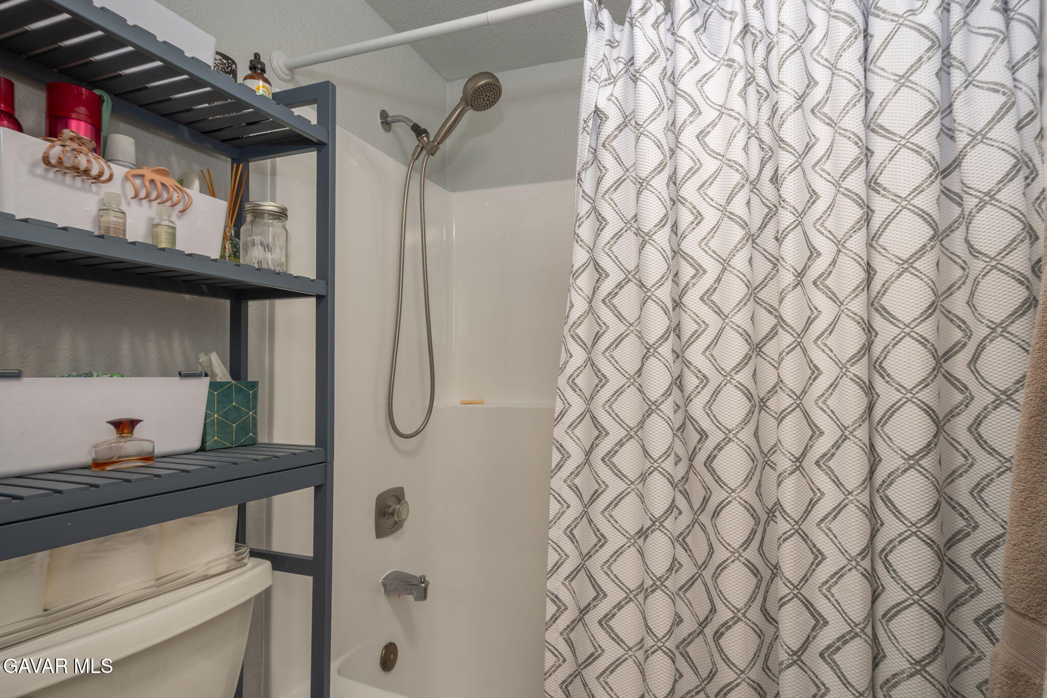 44442 15th Street East, Unit 5 Lancaster, CA 93535 - Photo 14 of 23 a bathroom with a granite countertop sink and a shower curtain