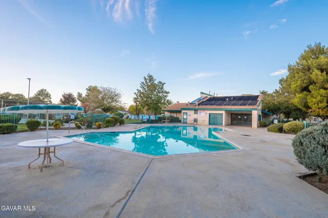 a wooden bench sitting in front of a house