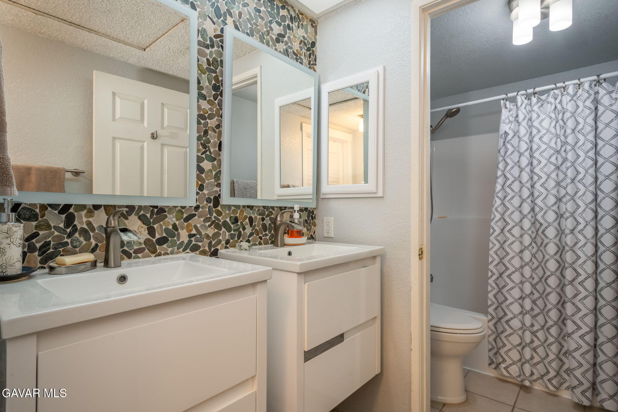44442 15th Street East, Unit 5 Lancaster, CA 93535 - Photo 23 of 23 a bathroom with a sink toilet and shower