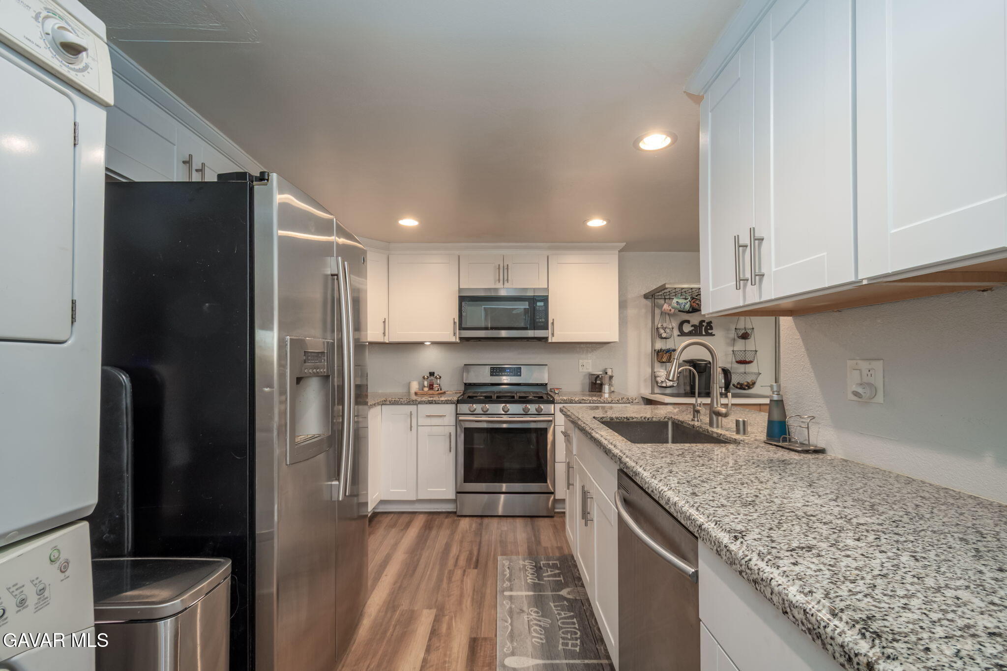 44442 15th Street East, Unit 5 Lancaster, CA 93535 - Photo 3 of 23 a kitchen with a sink stove and refrigerator