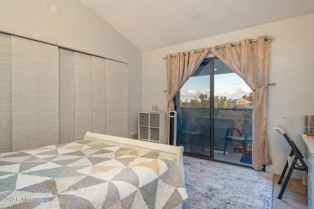 a bedroom with a bed and a table