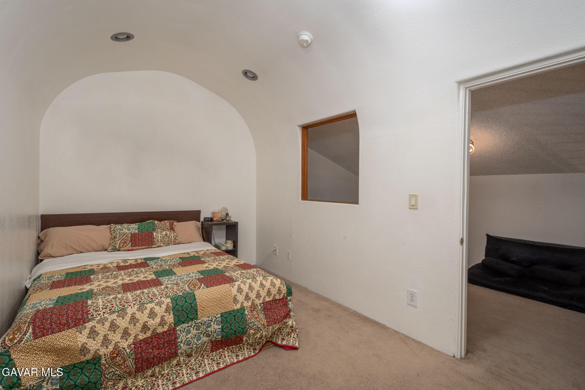 44442 15th Street East, Unit 5 Lancaster, CA 93535 - Photo 10 of 23 a bedroom with a bed and a painting on the wall