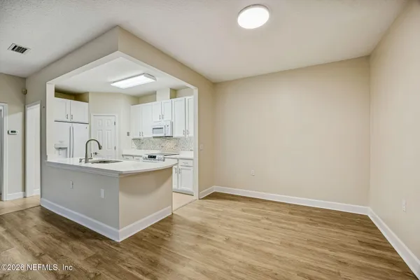 a bathroom with a sink vanity mirror and toilet