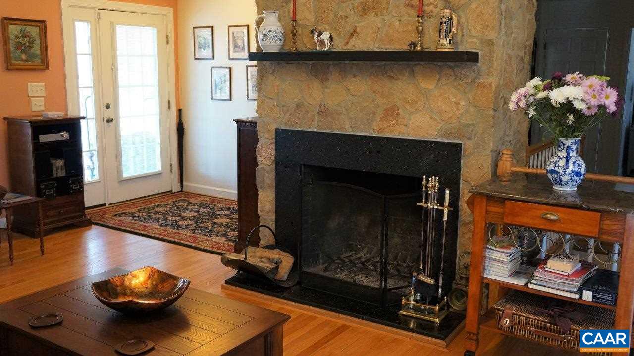 3621 Keswick Road Keswick, VA 22947 - Photo 15 of 50 a living room with furniture and a fireplace