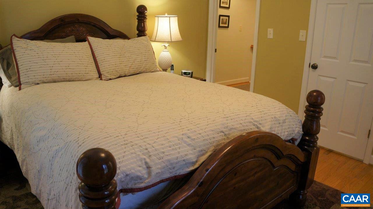 3621 Keswick Road Keswick, VA 22947 - Photo 23 of 50 a bedroom with a bed and a painting on the wall