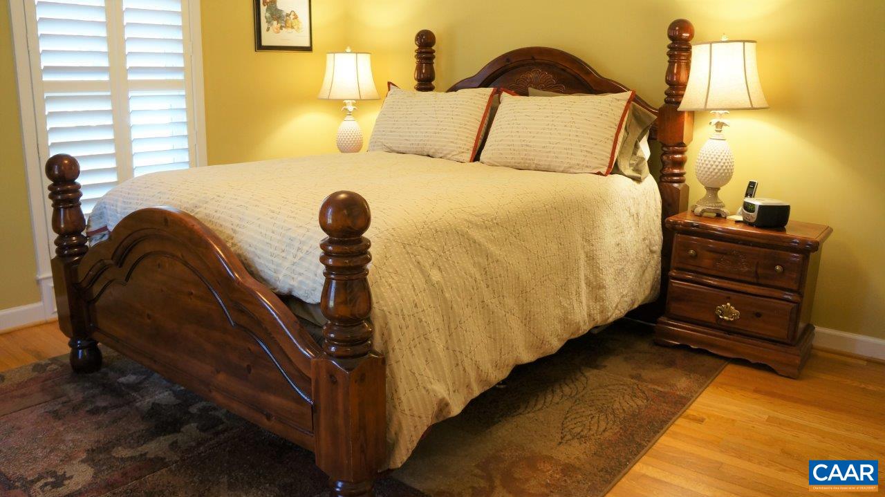 3621 Keswick Road Keswick, VA 22947 - Photo 24 of 50 a bedroom with a bed and wooden floor