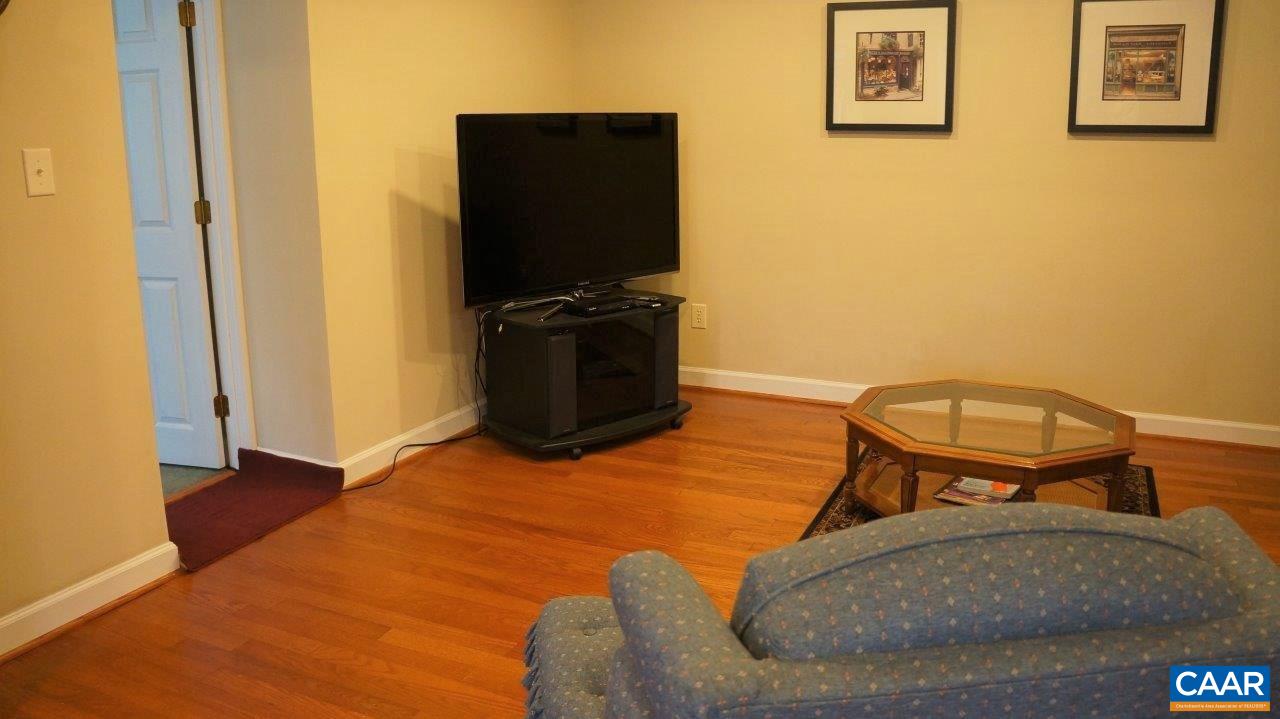 3621 Keswick Road Keswick, VA 22947 - Photo 32 of 50 a living room with furniture and a flat screen tv