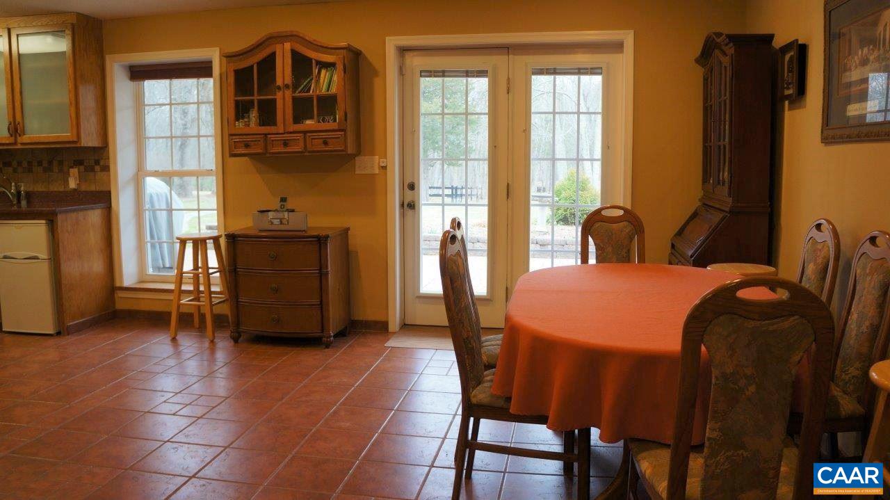 3621 Keswick Road Keswick, VA 22947 - Photo 34 of 50 a dining room with a table chairs and a kitchen view