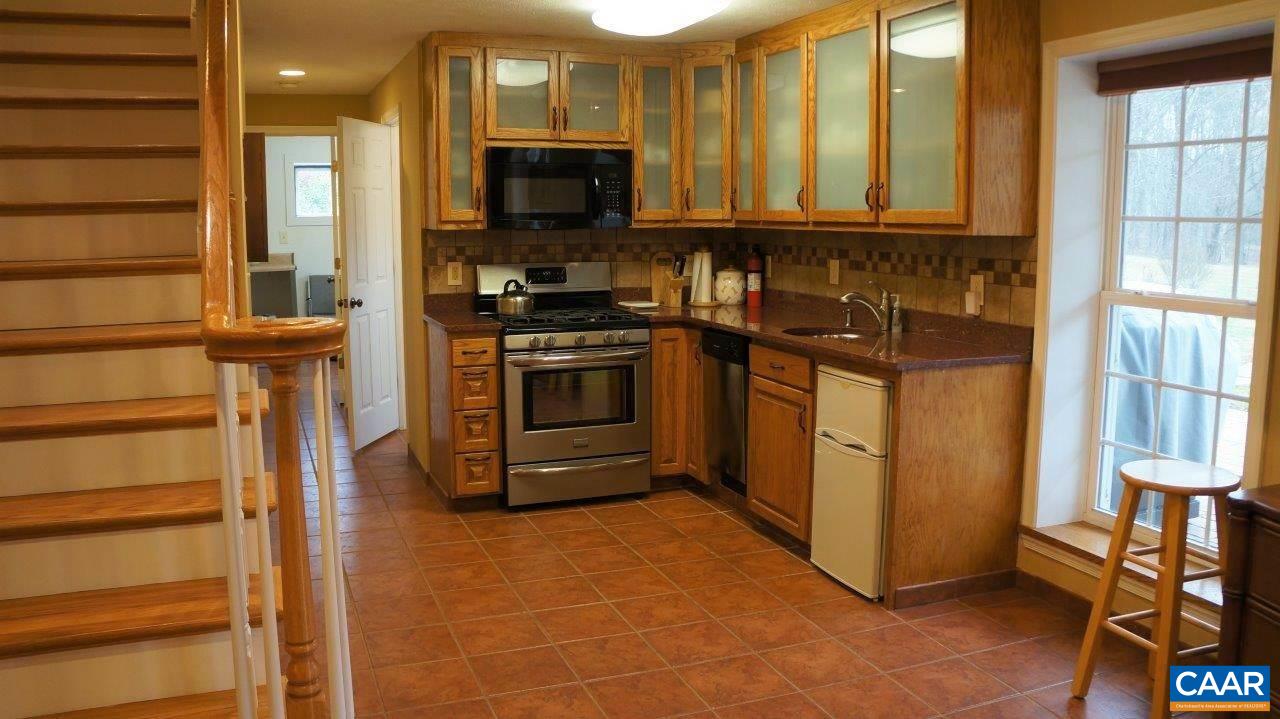 3621 Keswick Road Keswick, VA 22947 - Photo 35 of 50 a kitchen with stainless steel appliances a stove a microwave and a refrigerator