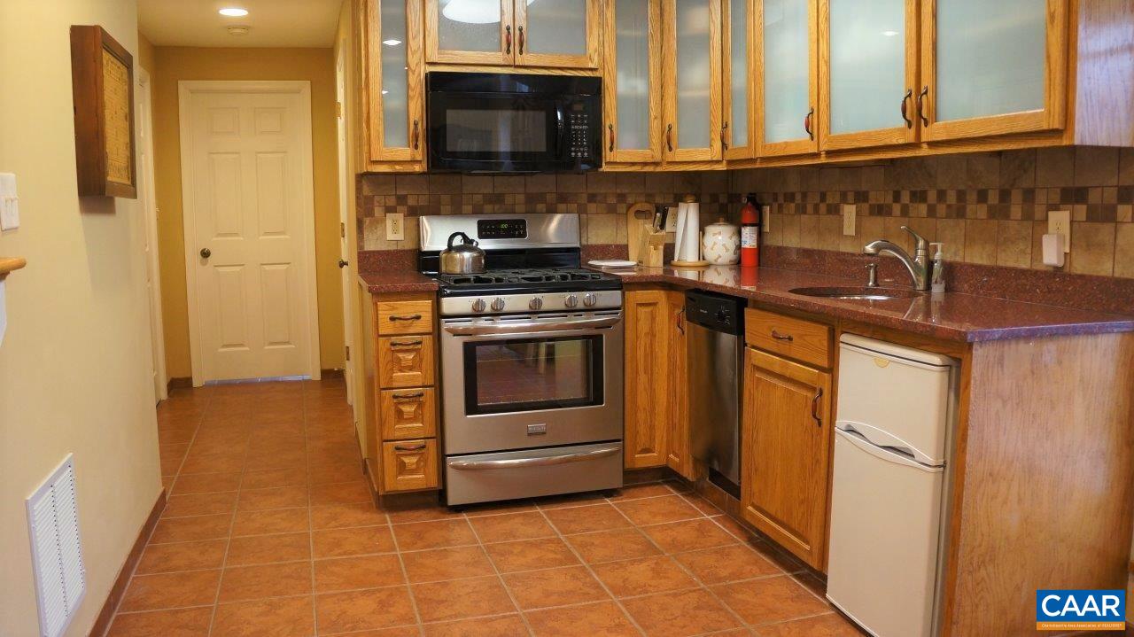 3621 Keswick Road Keswick, VA 22947 - Photo 36 of 50 a kitchen with stainless steel appliances granite countertop a stove and a refrigerator